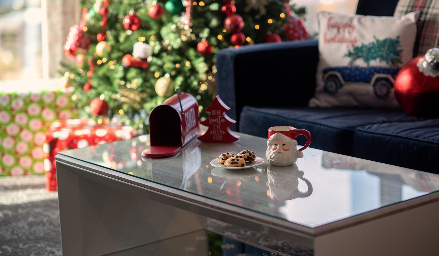 Amway Grand_Santa Suite_Living Room_Table_Couch_Christmas Tree_Presents_Mailbox_Cocoa Mug_Cookies_Pillows_Blanket