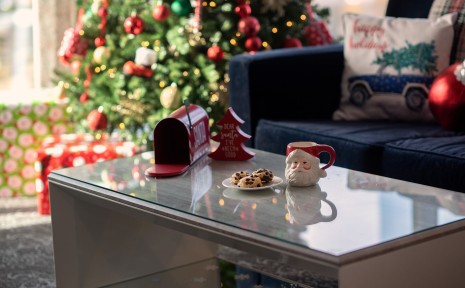 Amway Grand_Santa Suite_Living Room_Table_Couch_Christmas Tree_Presents_Mailbox_Cocoa Mug_Cookies_Pillows_Blanket