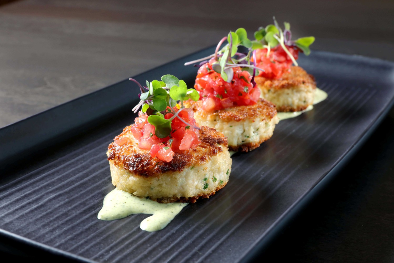 Amway Grand_The Kitchen by Wolfgang Puck_Crab Cakes_Plate_Tomatoes_Sauce