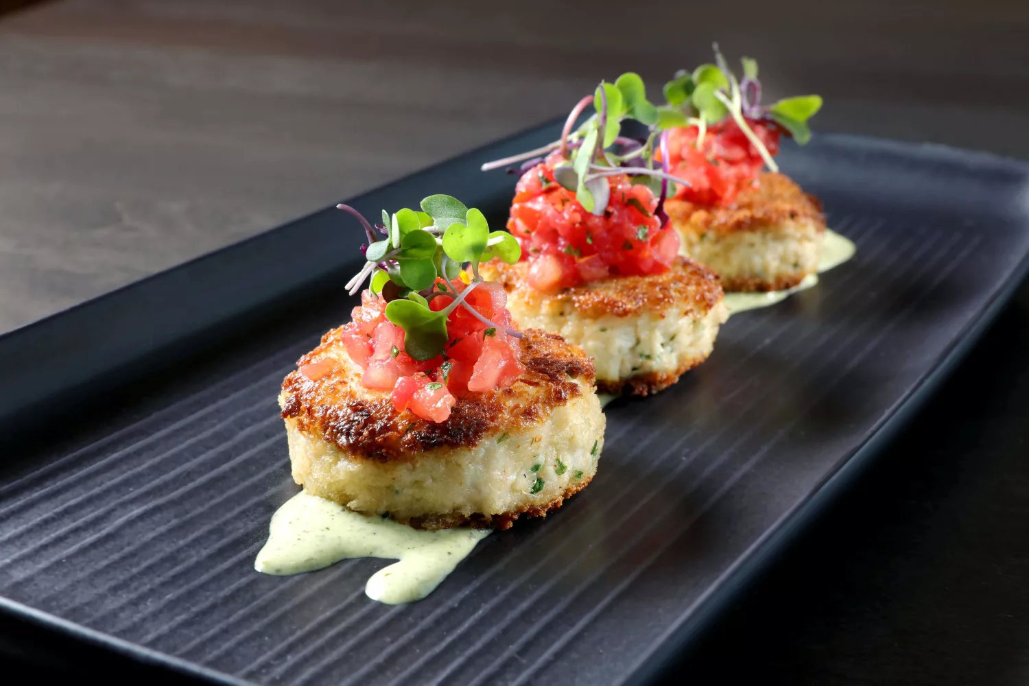 Amway Grand_The Kitchen by Wolfgang Puck_Crab Cakes_Plate_Tomatoes_Sauce