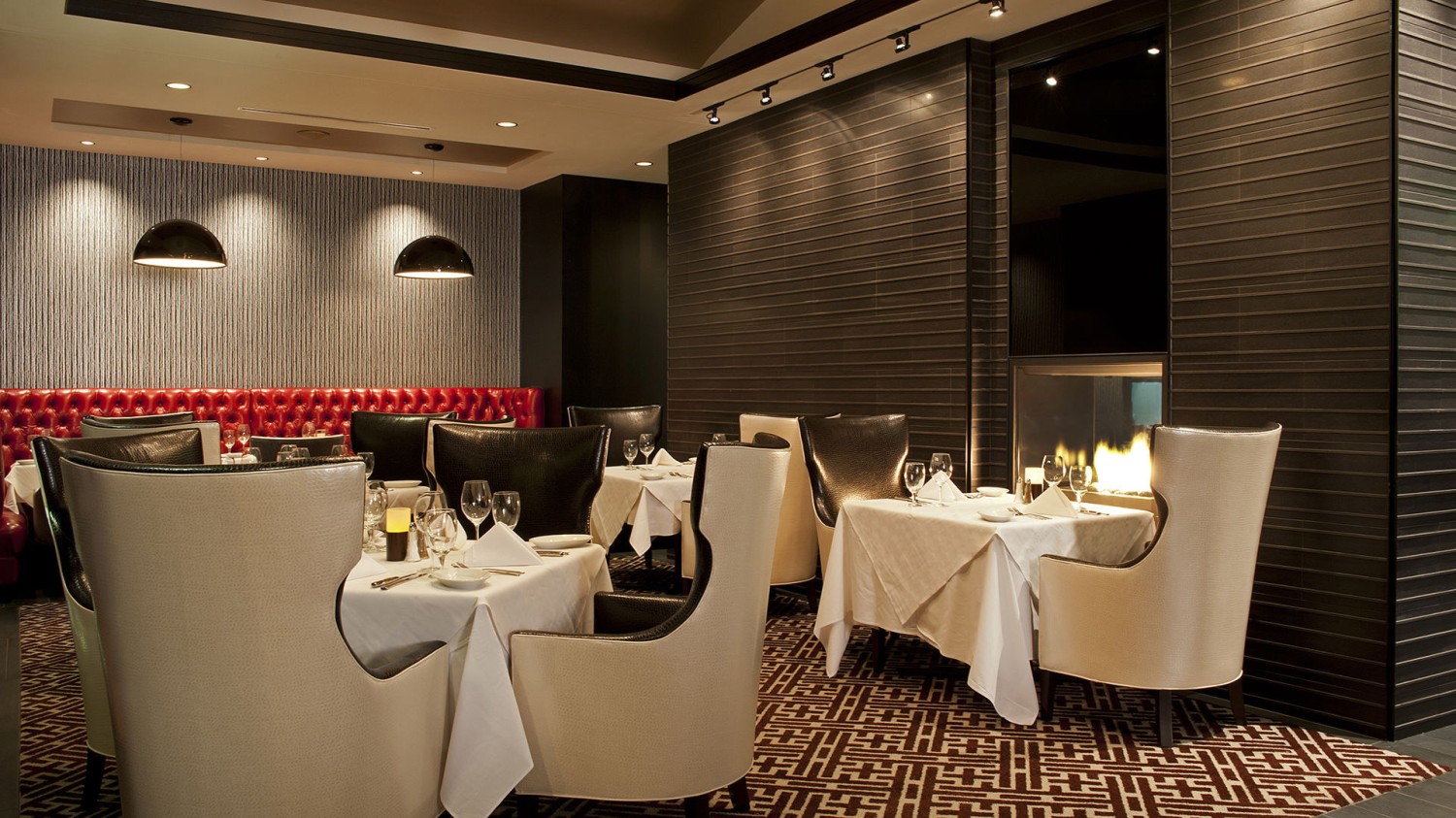 Amway Grand_Ruths Chris Steak House_Private Dining Room_Tables_Chairs_Candles_Linen_Bench_Hanging Lights_Glasses_Silverware_Napkins