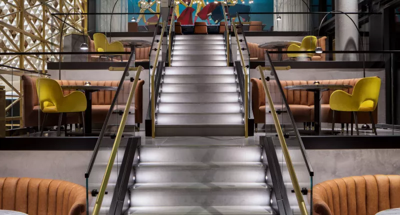 Amway Grand_MDRD_Stadium Seating Area_Benches_Tables_Raining_Spanish Mural_ Chairs_Stairs