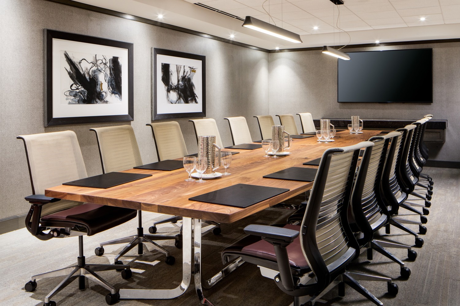 Amway Grand_Fine Arts Meeting Room_Meeting Room_Set Up_Long Table_Chairs_Notepads_Pens_Water Bottles_Paintings_TV_Flowers