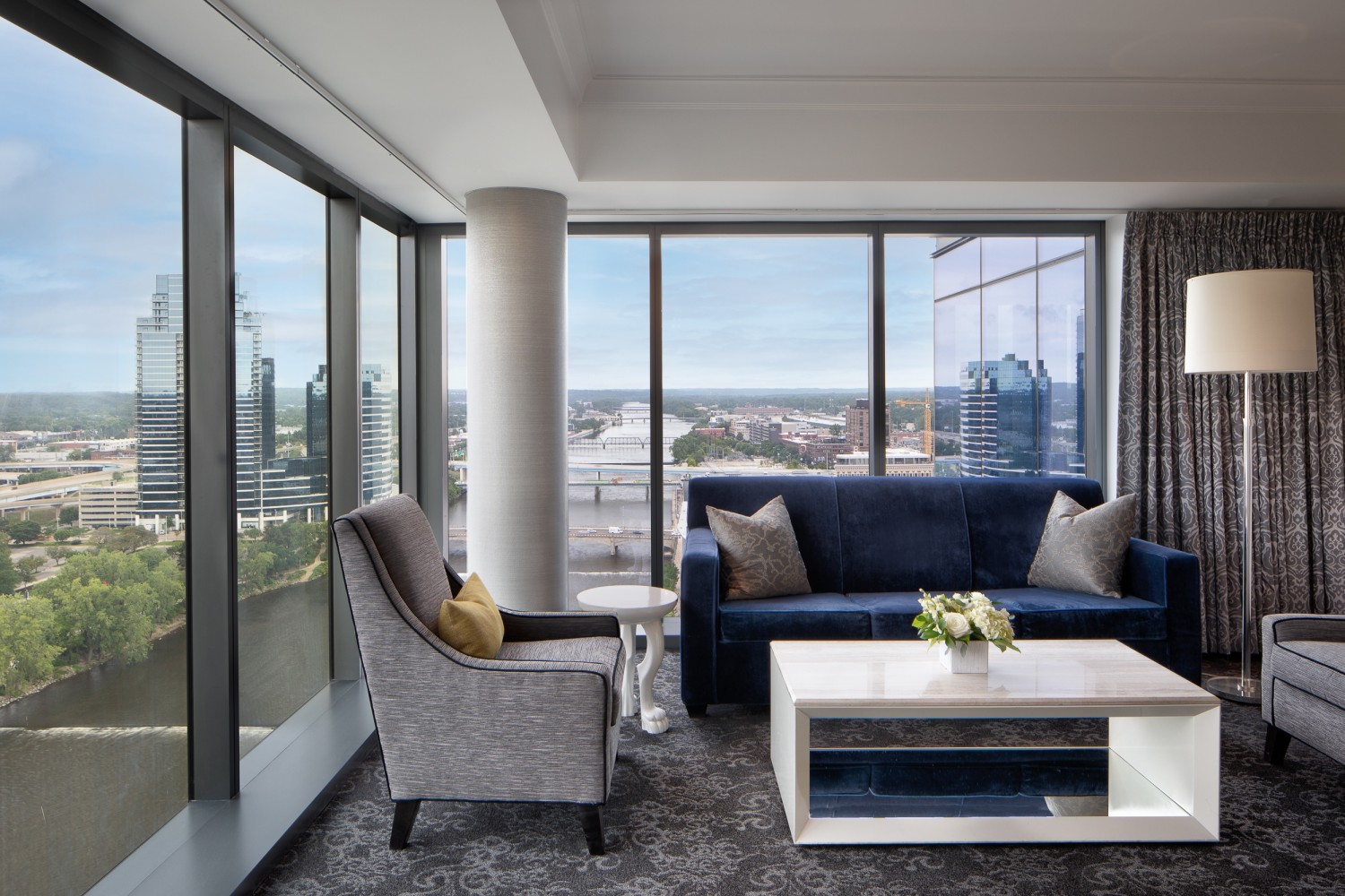 Amway Grand_Tower Luxury Suite_Living Room_Chairs_Couch_River View_Coffee Table_Lamp_Pillows