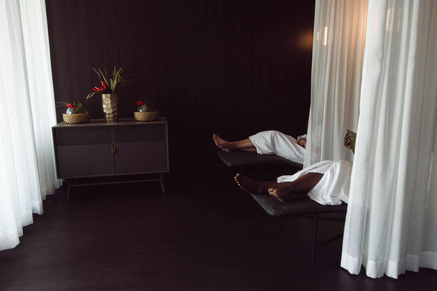 Amway Grand_Celeste Salon & Spa_Relaxation Lounge_Lounge Chairs_Women Sitting in Lounge Chairs_Robes_Cabinet_Flowers