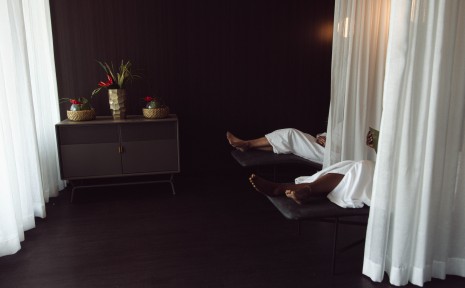 Amway Grand_Celeste Salon & Spa_Relaxation Lounge_Lounge Chairs_Women Sitting in Lounge Chairs_Robes_Cabinet_Flowers