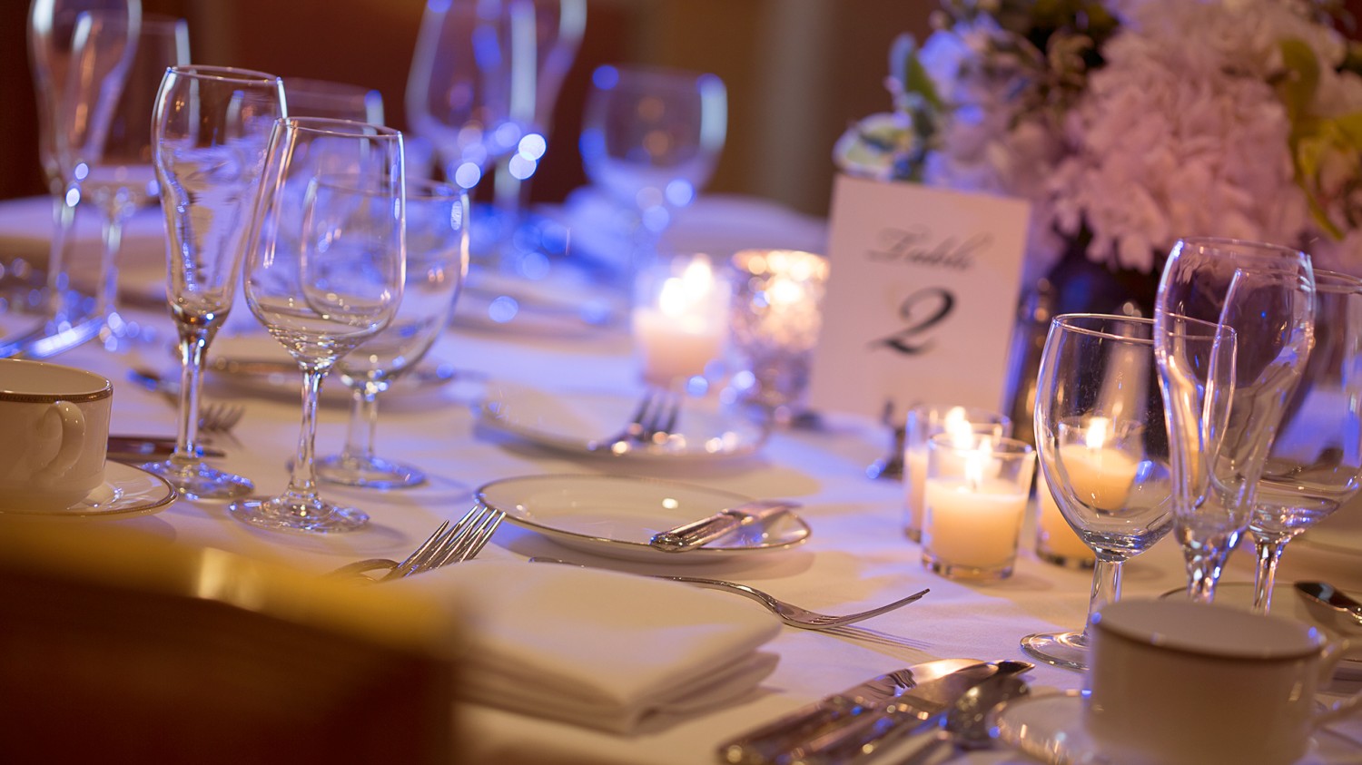 Amway Grand_Wedding_Set Up Detail Shot_Table Number_PLates_Napkins_Glasses_Silverware_Flowers_Candles