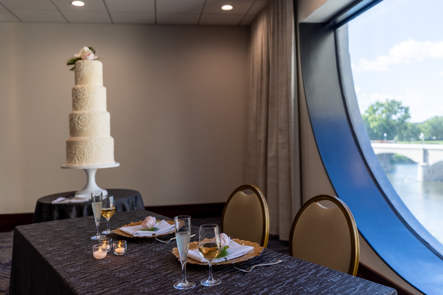 Amway Grand_Pearl Room_Wedding_Set Up_Tables_Linen_Candles_Glasses_Cake_Napkins_Silverware_Big Round Window
