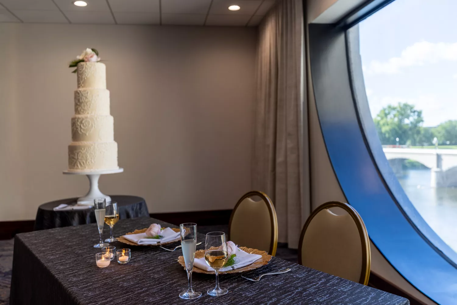 Amway Grand_Pearl Room_Wedding_Set Up_Tables_Linen_Candles_Glasses_Cake_Napkins_Silverware_Big Round Window